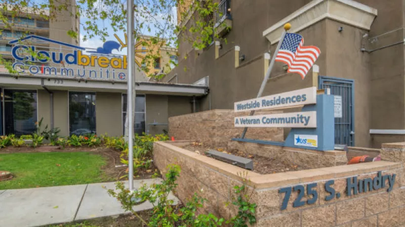 Meruelo Residences A Veteran Community building. An American flag and "725 S. Hindry" address sign are visible.